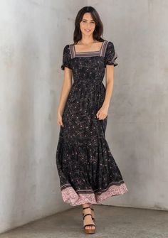 A flattering square neckline adds a trendy touch to this classic bohemian maxi dress. Designed in a floral border print, featuring flirty short puffed sleeves, an elastic waist for definition, and a tiered skirt for added shape and movement. A versatile maxi dress for your next special occasion. Black Bohemian Dress With Tiered Skirt, Casual Maxi Dress With Ruffle Hem And Square Neck, Black Bohemian Tiered Maxi Dress, Black Tiered Bohemian Maxi Dress, Black Boho Print Maxi Dress, Black Bohemian Maxi Dress With Smocked Back, Casual Black Maxi Dress With Boho Print, Fitted Black Maxi Dress With Boho Print, Pink Floral Border