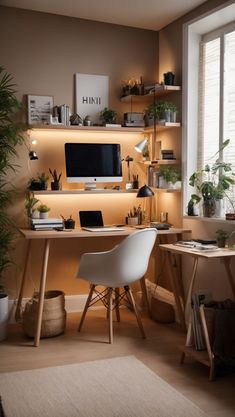 a desk with a computer on top of it next to a window and potted plants