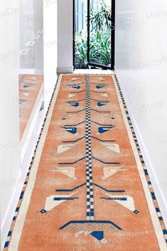 an orange and blue rug is on the floor in front of a doorway with glass doors