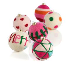 christmas ornaments with the word merry written on one ornament in red, white, and green