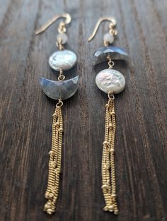 Born under the celestial magic of a lunar eclipse, these earrings embody the wonder of the night sky. Moonstone accent Beads & Labradorite crescent moons, imbued with an otherworldly shimmer, hang alongside luminous white freshwater pearls, resembling a full moon and it's craters. Delicate satellite chains  complete the celestial lunar eclipse look, making these earrings a truly unique and captivating piece. Available in Sterling Silver & 14k Gold Filled Handmade Celestial Metal Earrings, Mystical Moon Phase Dangle Earrings, Handmade Celestial Brass Earrings, Celestial Moon-shaped Metal Earrings, Handmade Moon-shaped Spiritual Earrings, Handmade Jewel, Metal Clay Jewelry, Earrings Inspiration, Moon Earrings