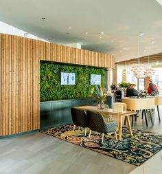 a living wall in the middle of a dining room