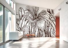 a living room with a large wall mural in the middle and palm trees on it