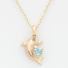 Oceans of beauty. Featuring a heart-cut blue topaz stone and tiny diamond accent, this 18k gold-over-sterling silver dolphin pendant is dazzling. Wear this charming necklace with absolutely any ensemble. Click on this JEWELRY & WATCHES GUIDE to learn about fit, styles, materials and more! Brass chain offers a lovely glow. Necklace comes in a gift box. Details: 7/8-in. pendant 18-in. chain Spring-ring clasp 18k gold over sterling silver & brass Image(s) may be enlarged to show detail. Diamond wei Glow Necklace, Dolphin Jewelry, Dolphin Necklace, Blue Topaz Stone, Blue Pendant, Tiny Diamond, Brass Necklace, Topaz Stone, Brass Chain