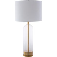 a clear glass lamp with a gold base and a white shade on the top, against a white background