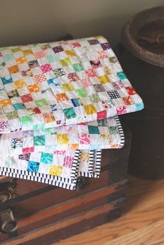 an old trunk with a quilt on it