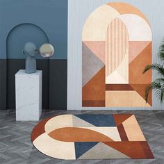 an abstract rug in the middle of a room next to a table with a lamp on it