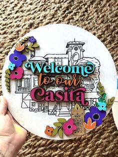 a person holding up a paper plate that says welcome to our easta