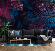 a living room with a couch, coffee table and wall mural