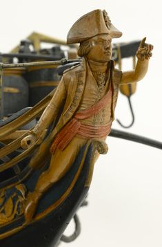 a wooden figurine sitting on top of a boat