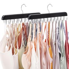 there are many bras hanging on the rack in front of each other, and one is empty