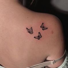 a woman with three butterflies on her back