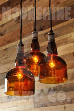 three light fixtures hanging from a wooden ceiling