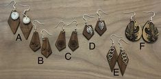 several different types of earrings are shown on a wooden surface with the letters abc and f