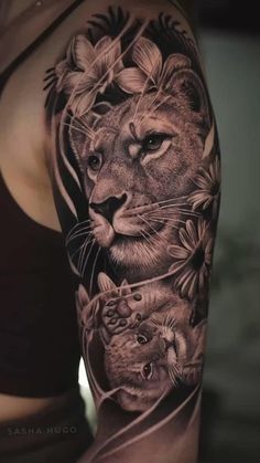 a woman's arm with an image of a lion and two cubs on it