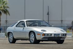 a silver sports car parked in a parking lot