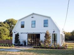 an instagramted photo of a white barn