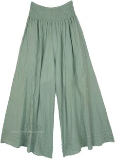 These cottage-core wide-leg pants are crafted from soft, breathable cotton, offering a comfortable and relaxed fit - and they have pockets! Designed with a high, elastic smocked shirred waistband, they are one size fits most.  The light sage green color adds a serene and natural touch, making these pants versatile and easy to pair with various tops. #tlb #SplitSkirtsPants #Misses #Fall #bohemianfashion #WideLegPants #HippiePants Comfortable Solid Color Spring Harem Pants, Comfortable Solid Color Harem Pants For Spring, Cotton Wide Leg Full-length Pants In Solid Color, Cotton Wide Leg Pants In Solid Color, Wide Leg Cotton Pants In Solid Color, Solid Color Cotton Wide Leg Pants, Bohemian Solid Wide Leg Pants With Pockets, Green Cotton Wide Leg Pants With Elastic Waistband, Bohemian Bottoms In Solid Color With Relaxed Fit