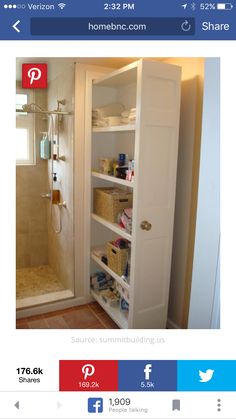 a walk in shower sitting next to a white sink under a bathroom window with towels on the shelves