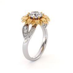 a white and yellow gold ring with two diamonds on the side, set in 18k gold