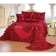 a bed with red ruffled bedspread and matching comforter in a bedroom