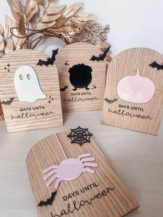 four wooden coasters with halloween decorations on them