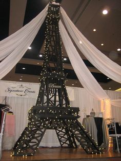 the eiffel tower is decorated with lights and draping for an event