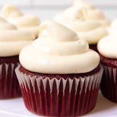 red velvet cupcakes with white frosting on a plate