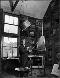 an old black and white photo of a man painting