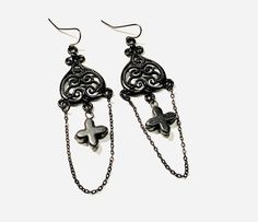 Glamour goth black cross filigree earrings with dainty black chain dangle. Perfect for your favorite dark outfit.  Measures: 3 inches from top to bottom ear wire is black enameled metal  VISIT MY SHOPS HERE   * http://www.etsy.com/shop/HappyCatHouse * http://www.Etsy.com/shop/AnEnchantingCreature  CONNECT  * http://www.facebook.com/EnchantingCreature * https://instagram.com/enchantingcreature * https://www.pinterest.com/enchantingcreature  NEW TO ETSY?  A great tutorial to answer all of your que Nickel Free Black Alternative Earrings, Alternative Style Black Earrings For Gift, Black Pierced Alternative Jewelry, Alternative Style Black Nickel-free Earrings, Black Metal Grunge Earrings, Black Pierced Emo Earrings, Alternative Style Nickel-free Black Earrings, Black Metal Emo Earrings, Ornate Black Dangle Jewelry