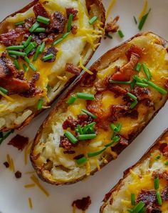 three loaded baked potatoes on a plate with green garnish and seasoning sprinkles