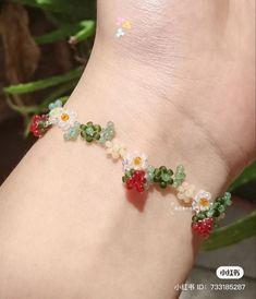 a woman's foot with flowers and beads on the side of her leg,