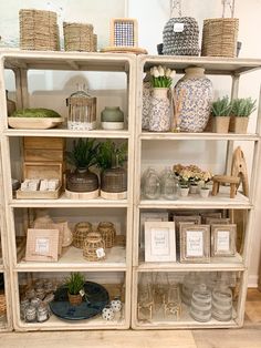 a shelf filled with lots of plants and baskets