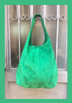 LARGE slouch leather bag in GREEN . Leather tote bag. Natural genuine SUEDE leather. NOT LINED. We added a small leather zipper pouch for your mobile phone and/or cards or money. It ist attached to the inside of the bag by a metal chain. This listing is for the bag in bright GREEN , there is a separate listing in our shop for moss green and also for the dark green bag on the last picture with the model. The bag is closed by a metal clip at the center. Width : 42cm - 16,5 in Height at the center: Suede Lined Hobo Tote Bag For Shopping, Green Soft Leather Hobo Bag For Shopping, Green Hobo Bag With Leather Handles For Daily Use, Green Leather Tote Hobo Bag, Green Leather Hobo Tote Bag, Green Tote Hobo Bag For Shopping, Green Double Handle Hobo Bag For Shopping, Green Suede Bags For Everyday Use, Green Suede Shoulder Bag For Everyday Use