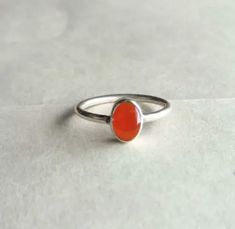 Pure carnelian Ring, 925 Sterling Silver Ring, Carnelian Jewelry , Handmade Ring , Carnelian Ring , Birthstone Jewelry, Proposal Ring. Details Handmade item Delivery from a small business in India Materials: Silver, Stone Gemstone: Onyx Gem colour: Orange Band colour: Silver Style: Art deco Recycled Made to Order Description Stone Name - Natural Carnelian Cabochon Cut Grade - Smooth Quality - AA- AAA Metal - 925 Sterling Silver Payment Policy We accept payment through PayPal Payment should be ma Oval Carnelian Orange Ring, Oval Orange Carnelian Rings, Orange Oval Carnelian Rings, Orange Carnelian Oval Cabochon Jewelry, Carnelian Gemstone Rings In Oval Cabochon Shape, Carnelian Orange Rings For Gifts, Orange Carnelian Ring Jewelry, Orange Carnelian Rings For Gifts, Handmade Orange Carnelian Rings