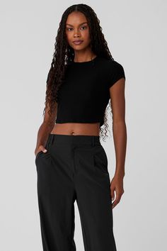 Cut from a soft, stretchy, ribbed fabric blend, this trusty tee is a closet staple you’ll want to buy in multiples. It has a classic crewneck, a slim fit, and not-too-short, not-too-long cap sleeves. Finished with a waist-length crop to pair perfectly with all your favorite high-waisted bottoms. Casual Ribbed Alo Yoga Tops, Alo Yoga Fitted Solid Color Tops, Fitted Alo Yoga Tops, Fitted Solid Color Alo Yoga Tops, Alo Yoga Fitted Casual Tops, Alo Yoga Fitted Everyday Tops, Alo Yoga Fitted Tops For Everyday, Black Ribbed Fitted T-shirt, Fitted Black Alo Yoga Tops