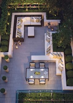 an aerial view of a living room and dining area in a backyard at night time