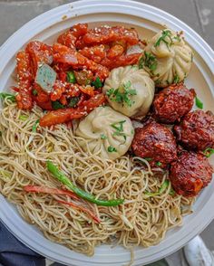 a white plate topped with pasta and meatballs