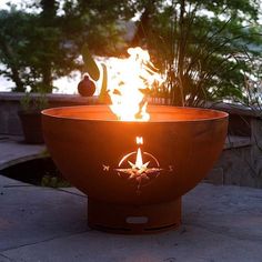 a fire pit sitting on top of a cement slab