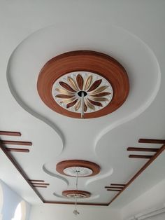 the ceiling is decorated with wood and white paint, along with an intricate flower design