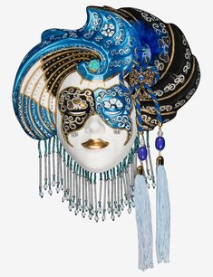 a blue and black mask with tassels hanging from it's sides