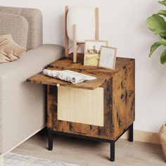 a wooden table sitting next to a couch in a living room with pictures on it