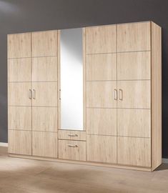 a large wooden wardrobe with mirrored doors and drawers