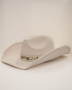 Add a touch of western glam to your outfit with our Cream Floral Embroidered Strap Cowboy Hat! This cute white cowboy hat features a strap embroidered with pretty flower details and pairs well with virtually anything. White Adjustable Felt Hat With Curved Brim, White Adjustable Curved Brim Felt Hat, White Flat Brim Hat For Ranch, White Wide Brim Felt Hat For Spring, White Flat Brim Felt Hat For Spring, White Western Felt Hat For Kentucky Derby, White Western Felt Hat For The Beach, White Western Hat For Spring, White Fedora Hat For Rodeo