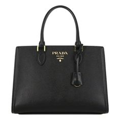 Carry your all your daily essentials in the Prada Saffiano Lux Black Leather Large Crossbody bag. This luxurious black bag pairs with any outfit and is the perfect versatile option as it includes both double handles and a detachable crossbody strap. The Prada saffiano leather bag opens to a canvas interior lining and offers both a zip and slip pocket. This sleek leather is perfect for traveling or date night! Model: 1BA228 Black Saffiano Leather Gold-tone hardware Detachable keyring Prada Milano Prada Nylon Shoulder Bag, Large Crossbody Bag, Prada Milano, Fashion Basics, Drawstring Purse, Red Leather Handbags, Prada Shoulder Bag, Large Crossbody Bags, Crossbody Satchel