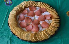 there is a pie with marshmallows in it on a green table cloth