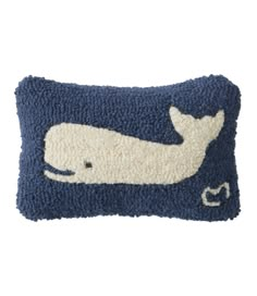 a blue pillow with a white whale on it