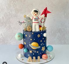 a birthday cake with an astronaut on top