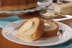 two pieces of bread sitting on top of a white plate next to another piece of cake