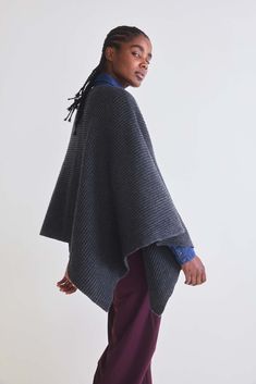 Stay comfortable and effortlessly fashionable with this versatile poncho that's ready to become your go-to choice for staying snug and stylish. Oversized fit Ribbed fabric Round neck Diagonal silhouette Draped sleeve Casual Cashmere Poncho For Fall, Oversized Cape For Cold Weather, Cozy Oversized Cape For Cold Weather, Oversized Cashmere Poncho For Winter, Oversized Soft Knit Cozy Poncho, Knit Poncho With Batwing Sleeves, Oversized Knit Winter Cape, Oversized Knit Poncho With Batwing Sleeves, Cozy Oversized Knit Cape